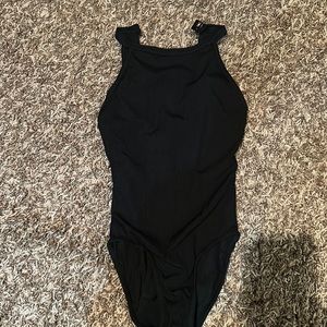 Solid black leotard with tiny ribbed, material and high neck with clip closure